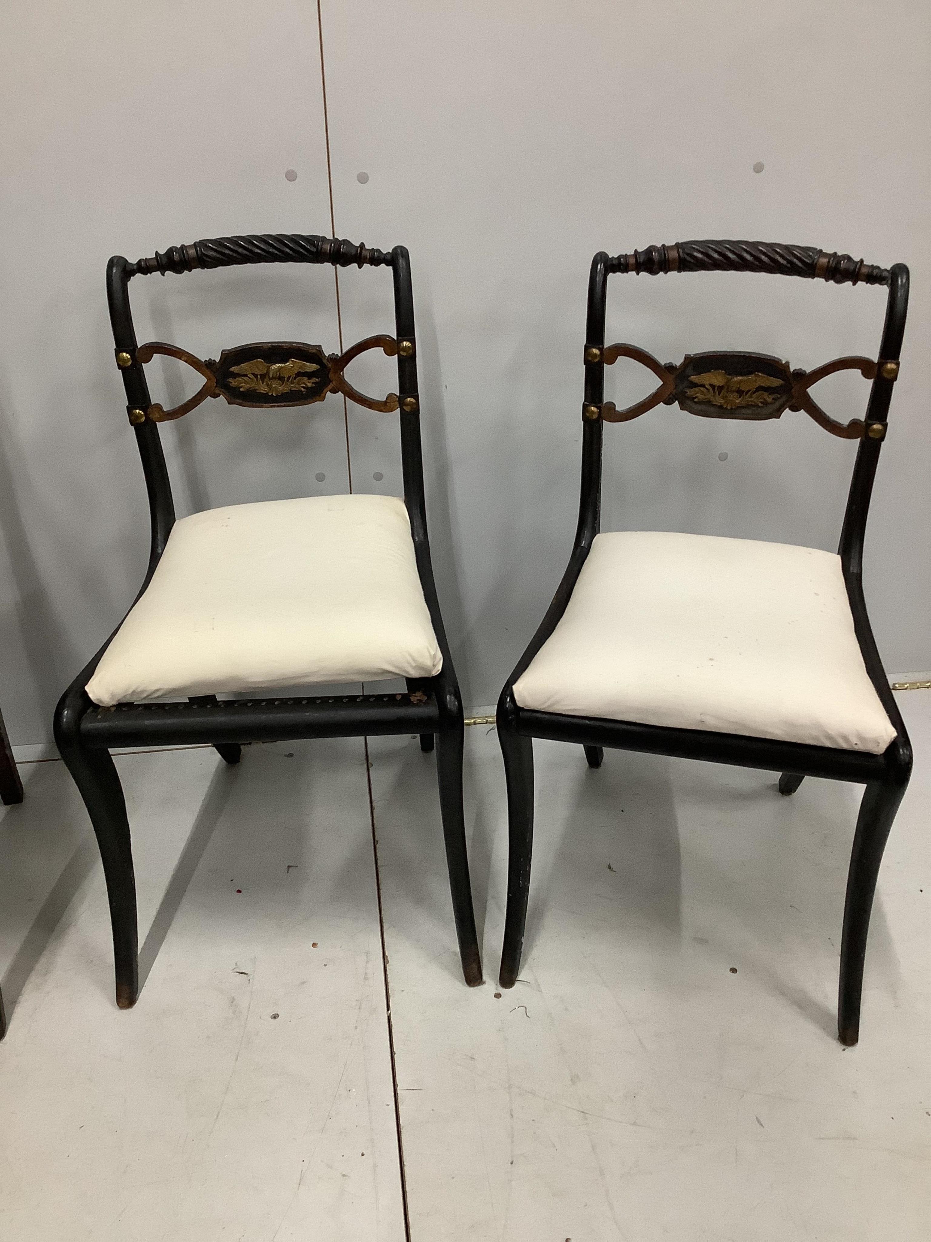 Two Regency mahogany and rosewood elbow chairs together with two Regency ebonised dining chairs. Condition - fair